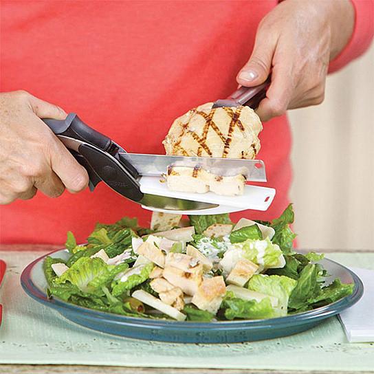 A person using Master Chop The Quick Easy Food Prep Dicer And Chopper in a red pot.