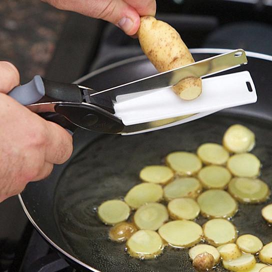 A person using Master Chop The Quick Easy Food Prep Dicer And Chopper in a red pot.