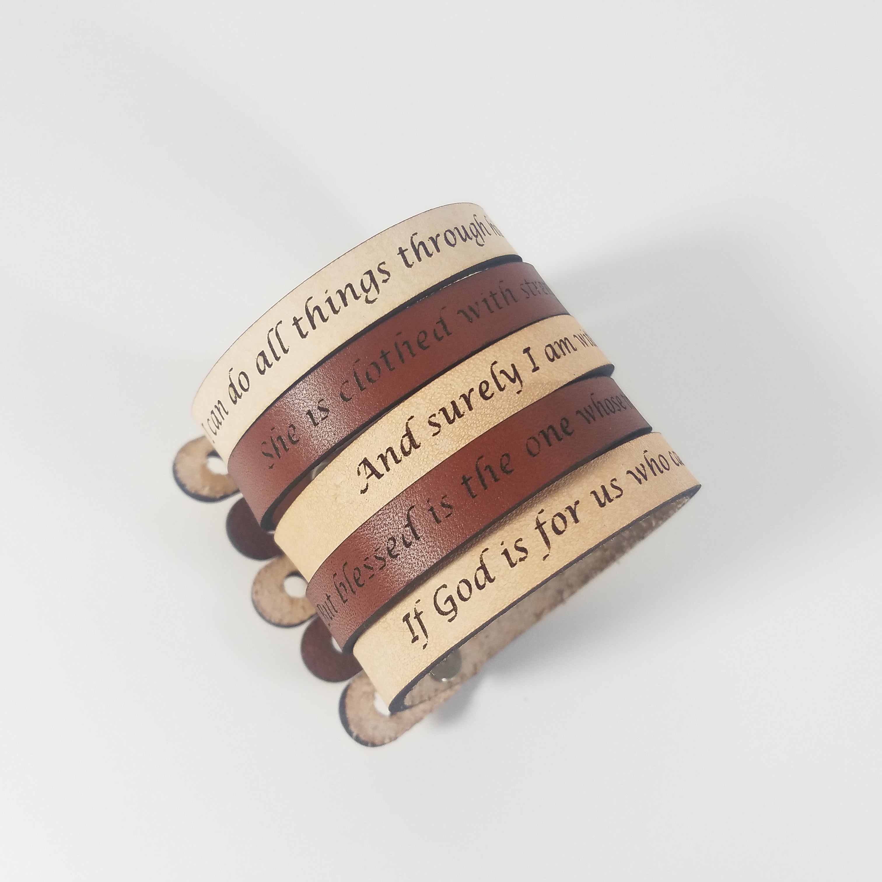 The Spiritual Quote Bracelet made of genuine leather features an adjustable button closure and is inscribed with the message: "If God is for us, who can be against us.