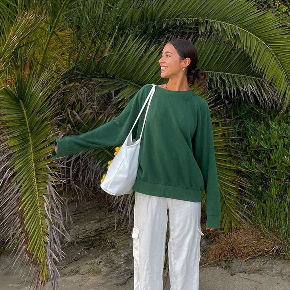 The Lily Canvas Shopper Tote is an eco-friendly cotton canvas bag featuring exquisite purple flower embroidery on the front.