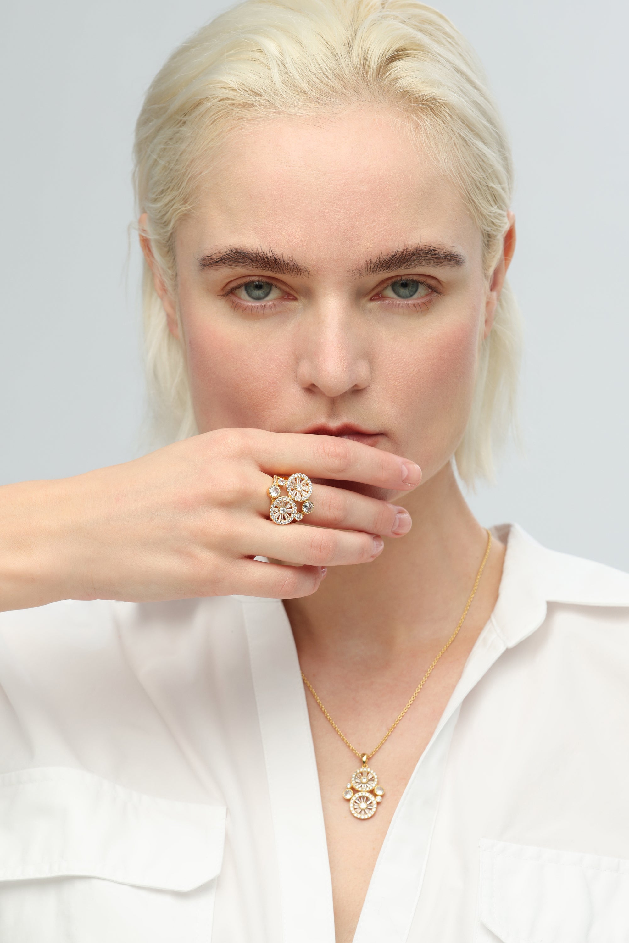 A Yellow Gold Wheel of Fortune Signet Ring with diamonds in the center.