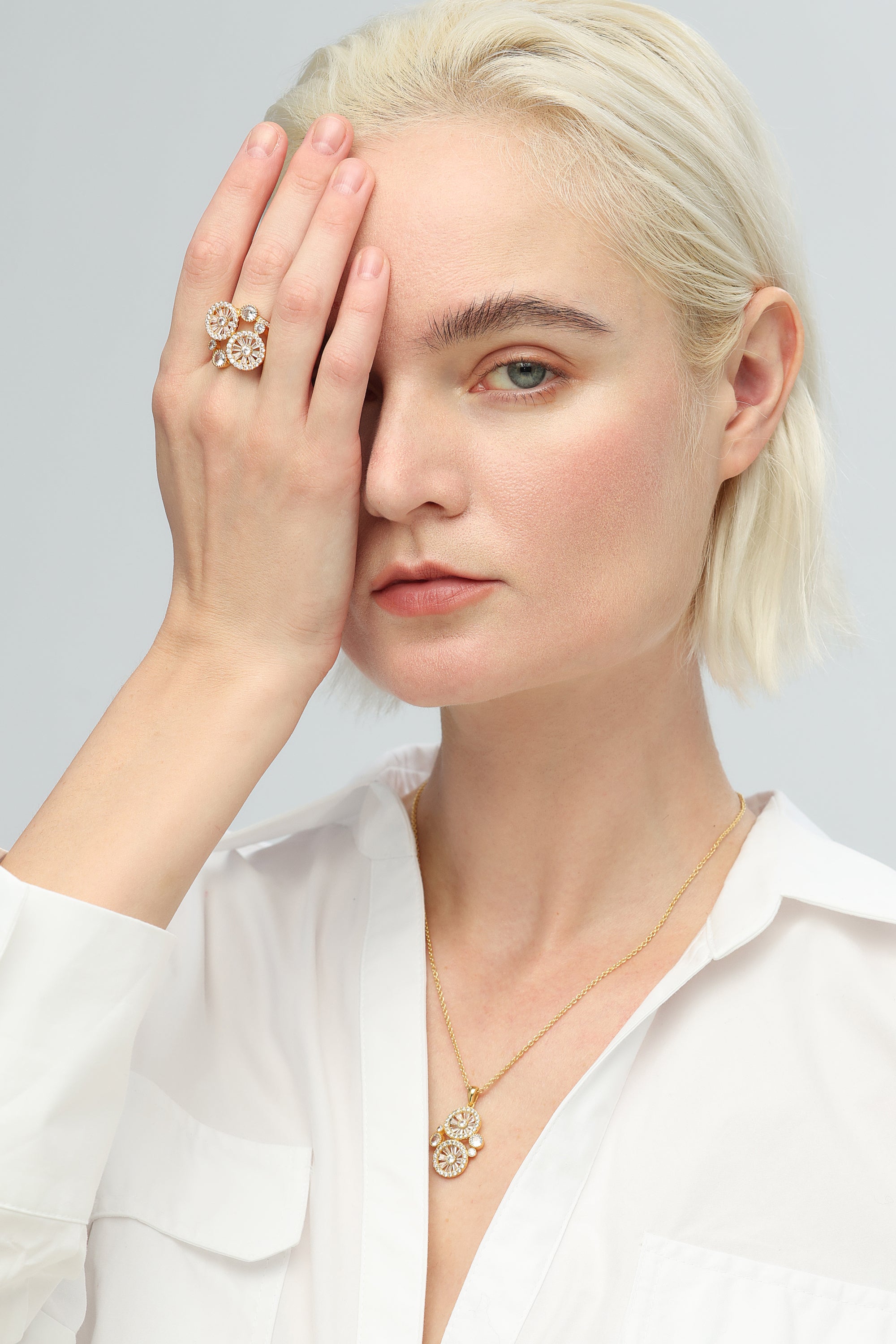 A Yellow Gold Wheel of Fortune Signet Ring with diamonds in the center.