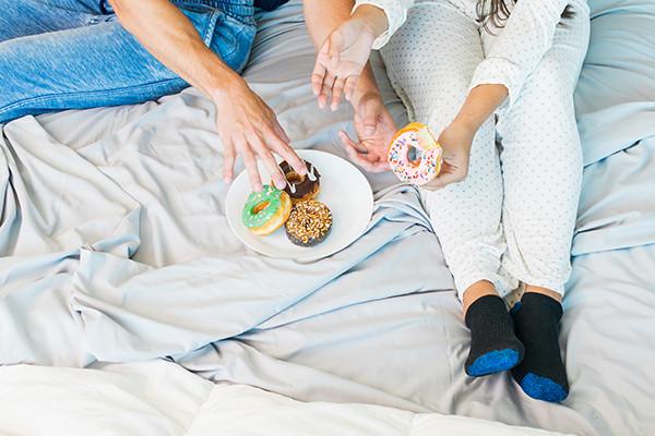 A stack of khaki sheets with wrinkles on a white background.