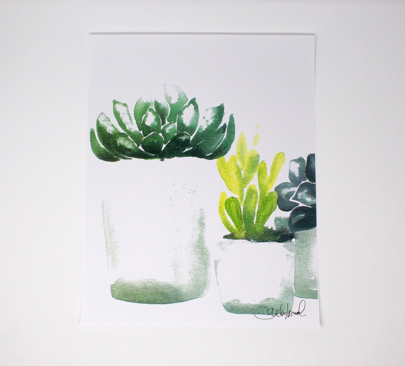 The Succulent Art Print (4) on 11x14 paper features a botanical art piece displaying three watercolor succulents in white pots against a light background, perfect for wall art and home decor.