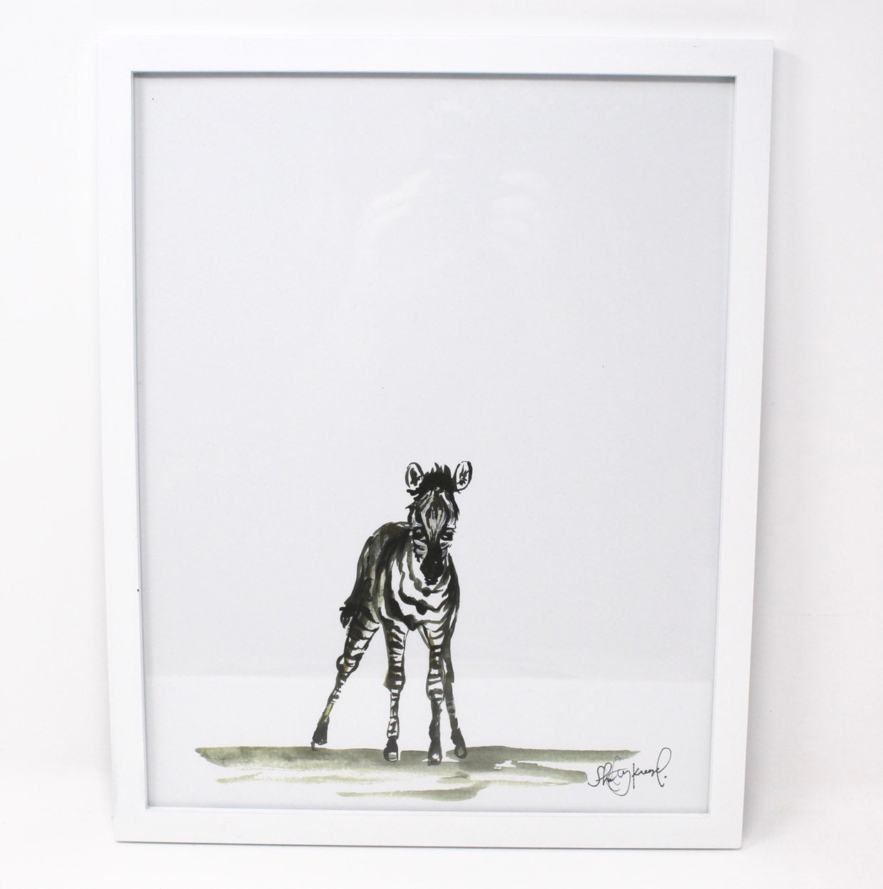 The Baby Zebra Art Print (11x14) is an ideal piece to add charm to a nursery wall or brighten up a baby room with its delightful depiction of a zebra on a blank background. Perfect for those who love animal art, it fits seamlessly into safari-themed home decor and nursery wall art collections.