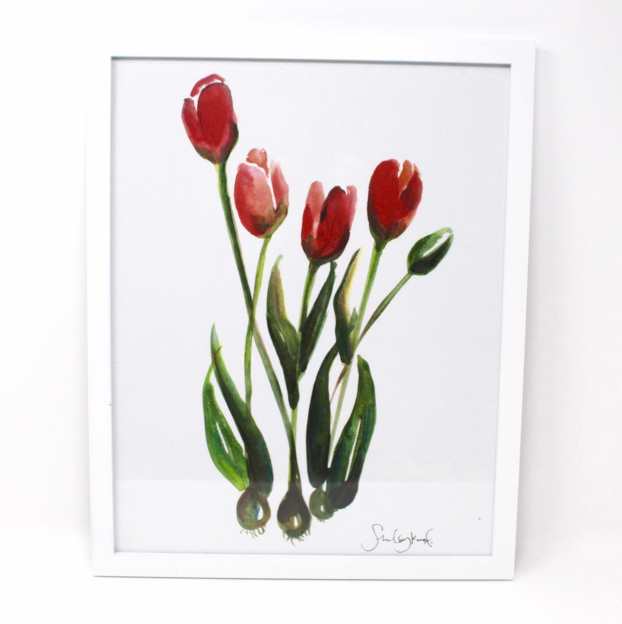 A wall art piece titled "Tulips Art Print," measuring 11x14, features a tulip painting with vibrant red tulips and lush green stems and leaves on a crisp white background, perfect for home decor.