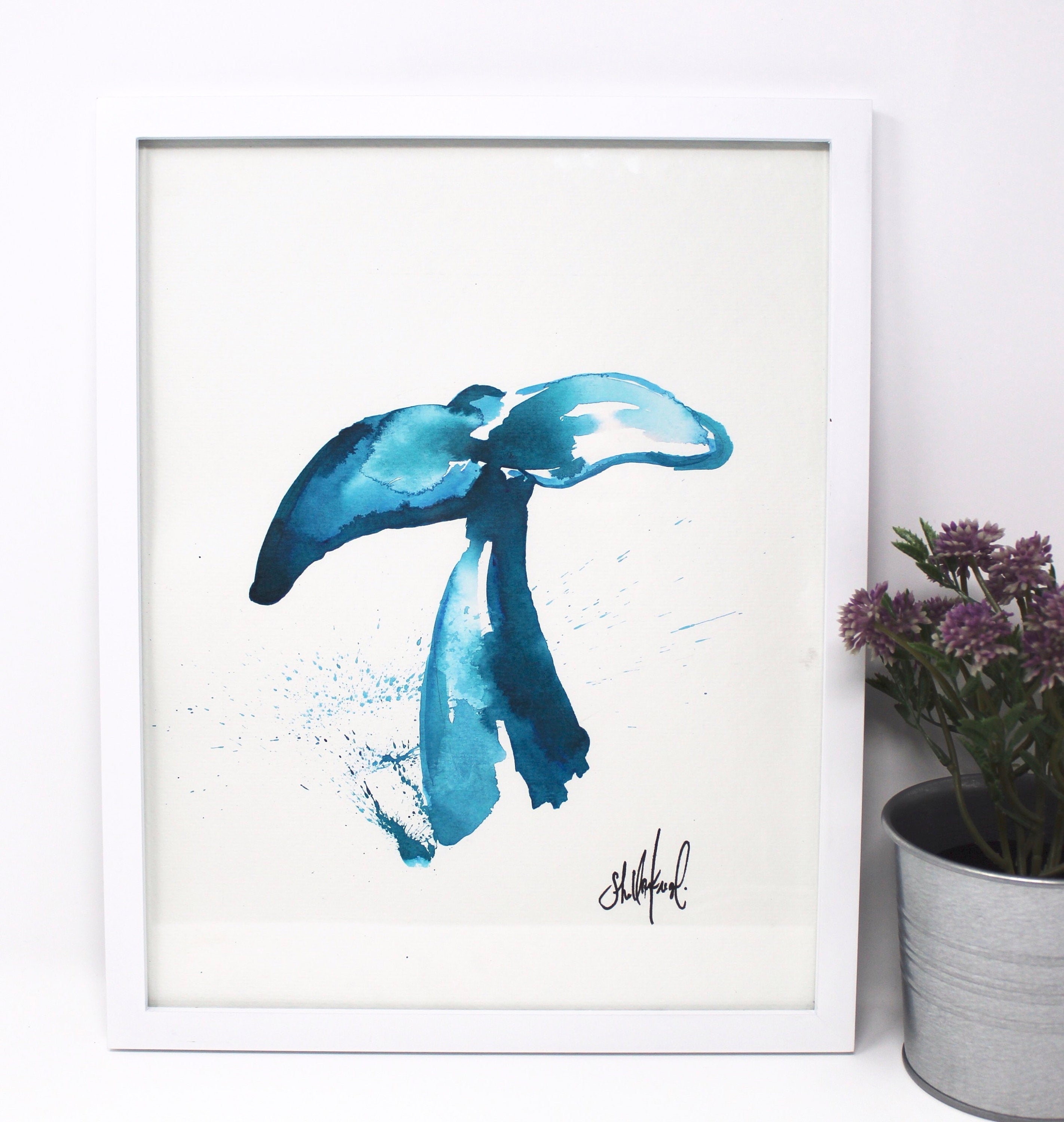 This Whale Art Print, titled "Whale Tail," measures 11x14 inches and features a coastal abstract design in shades of blue, reminiscent of a flowing whale tail. It comes framed in white with an artist's signature at the lower right corner. Ideal for a gallery wall, its tranquil tones capture the serene beauty of Southern California.