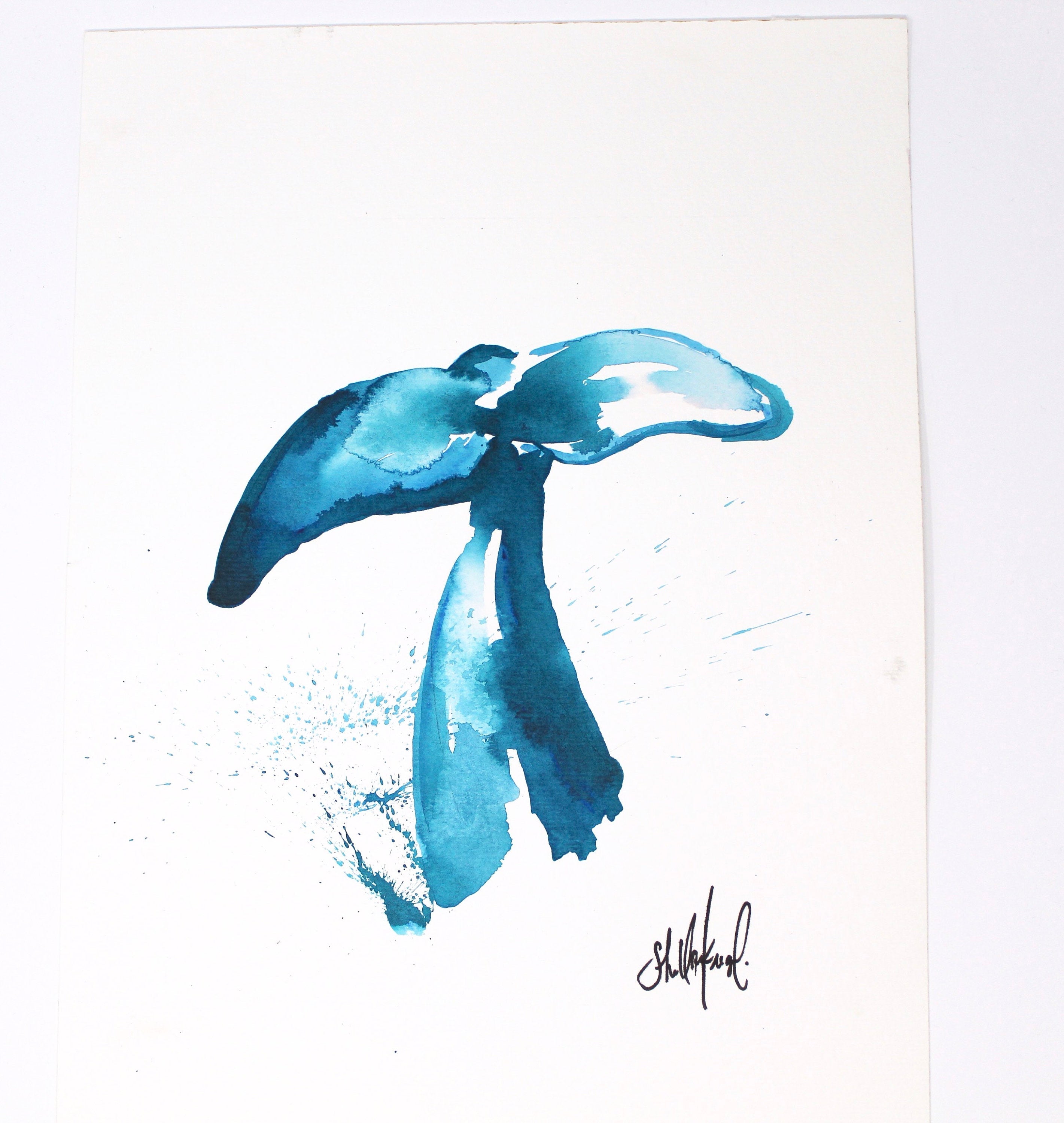 This Whale Art Print, titled "Whale Tail," measures 11x14 inches and features a coastal abstract design in shades of blue, reminiscent of a flowing whale tail. It comes framed in white with an artist's signature at the lower right corner. Ideal for a gallery wall, its tranquil tones capture the serene beauty of Southern California.