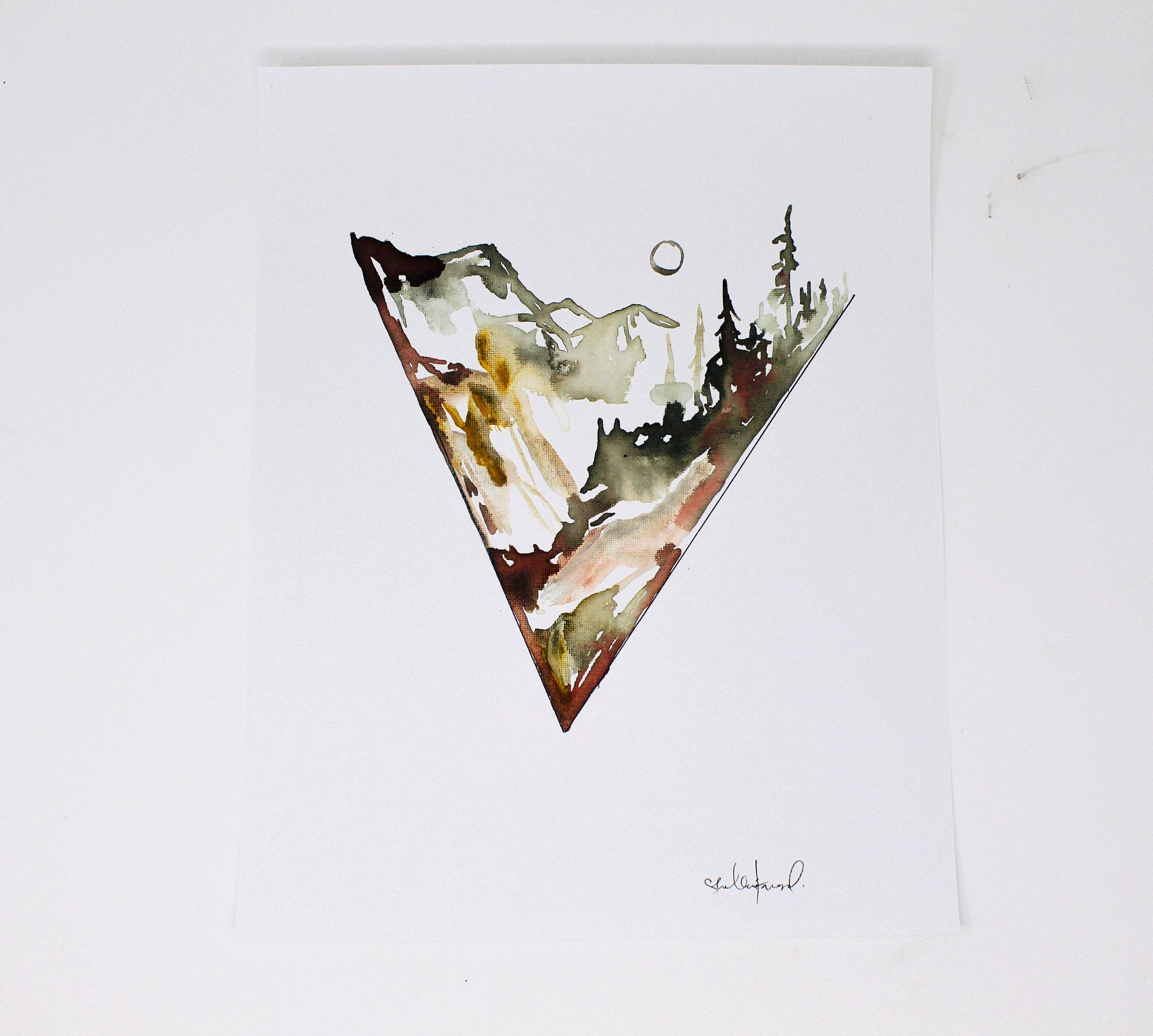 This Minimal Triangle Mountain Watercolor 11x14 Art Print, showcasing an elegant mountain landscape within an inverted triangle design, is perfect for adding a touch of adventure to a simple gallery wall.