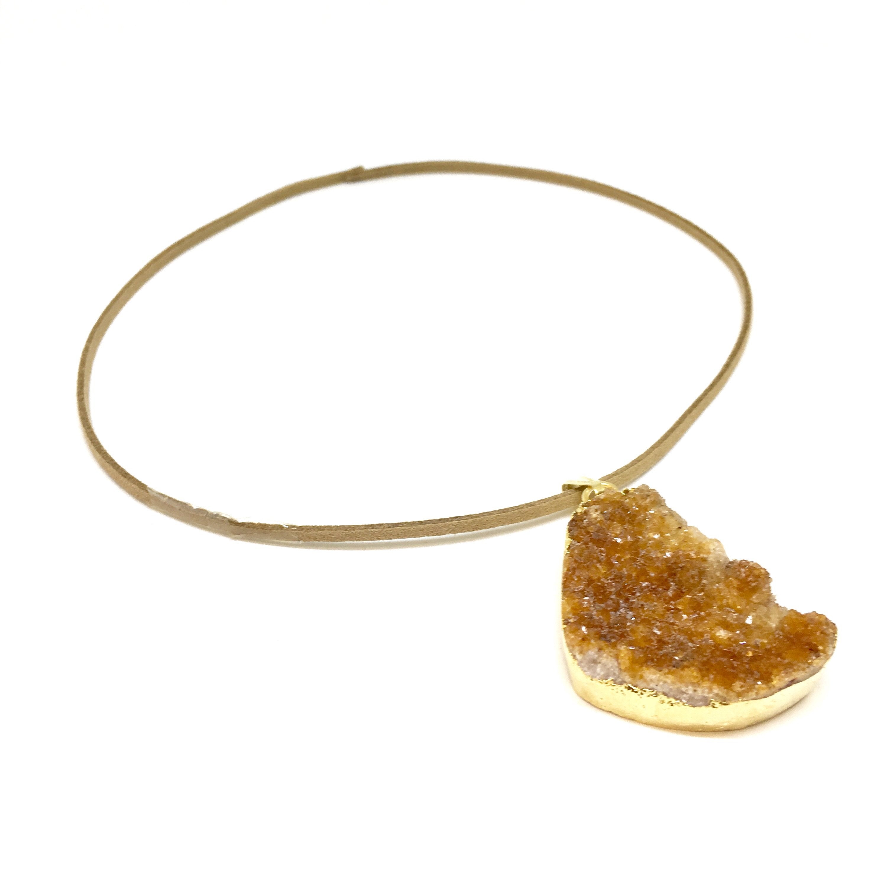 A triangular Orange Citrine Cluster Pendant with a gold clasp, displayed on a white background.