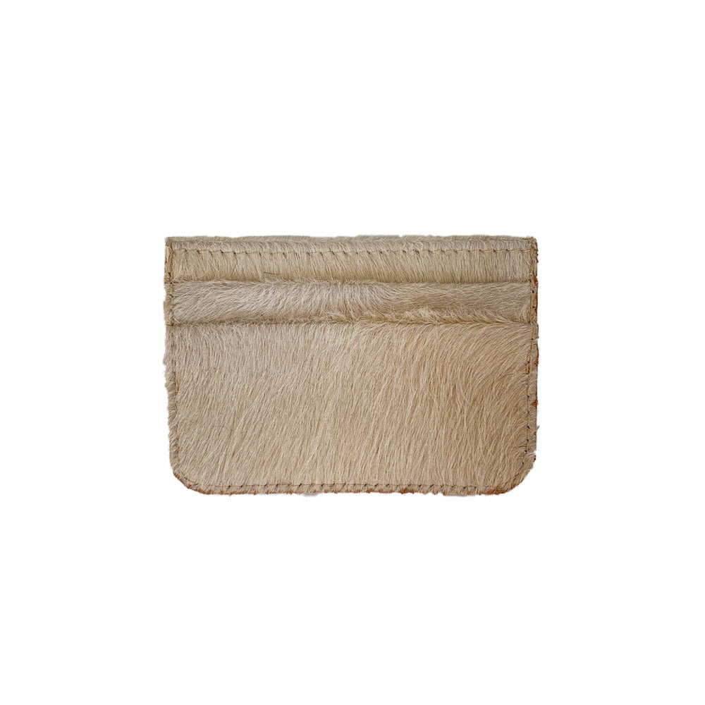 The Coco Card Holder is a minimalist tan and cream cowhide leather accessory, complete with stitched edges and practical card slots.