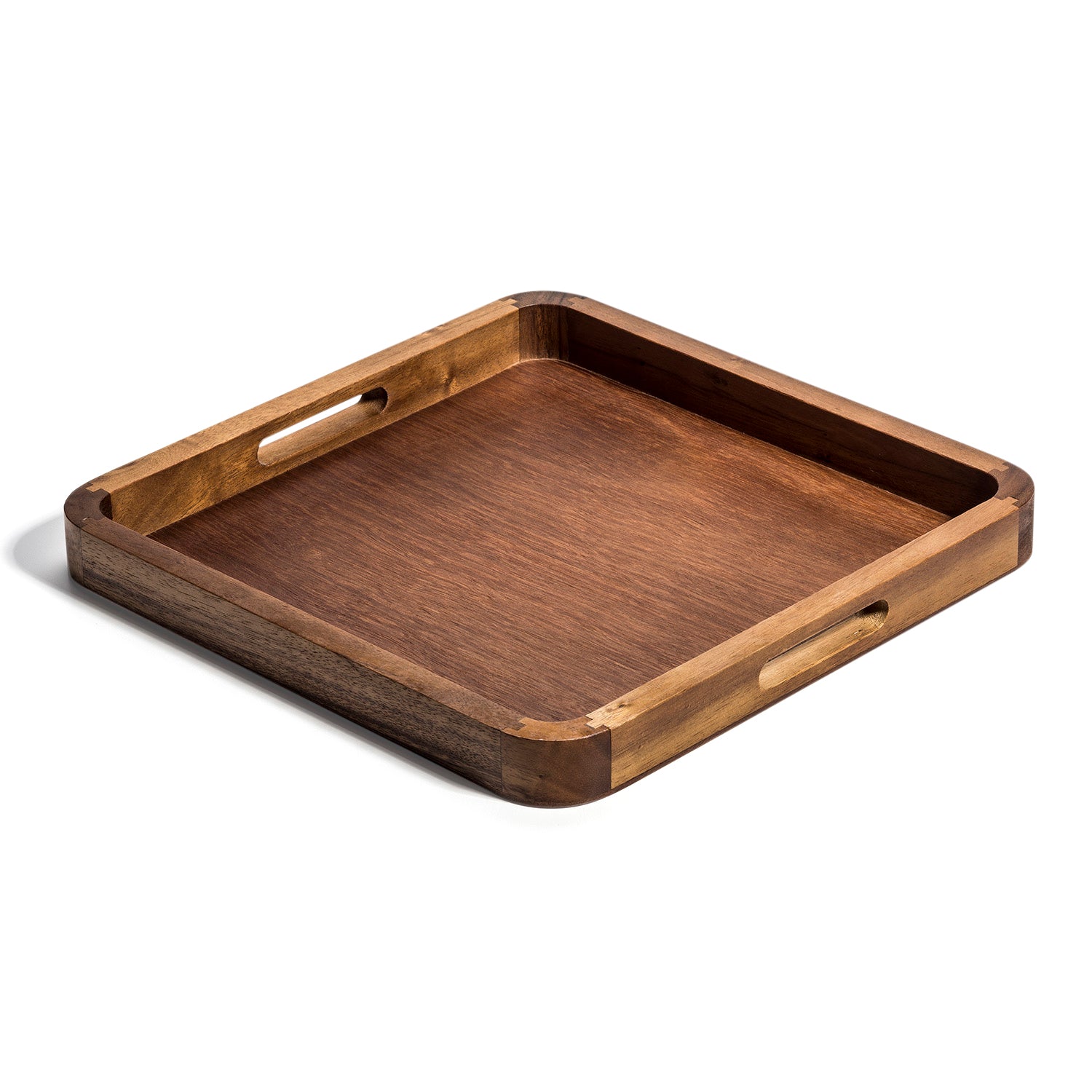 The Aalorg Square Serving Tray, made from Acacia wood, includes cut-out handles on each side. It serves both functional and decorative purposes, resting elegantly on any flat surface.