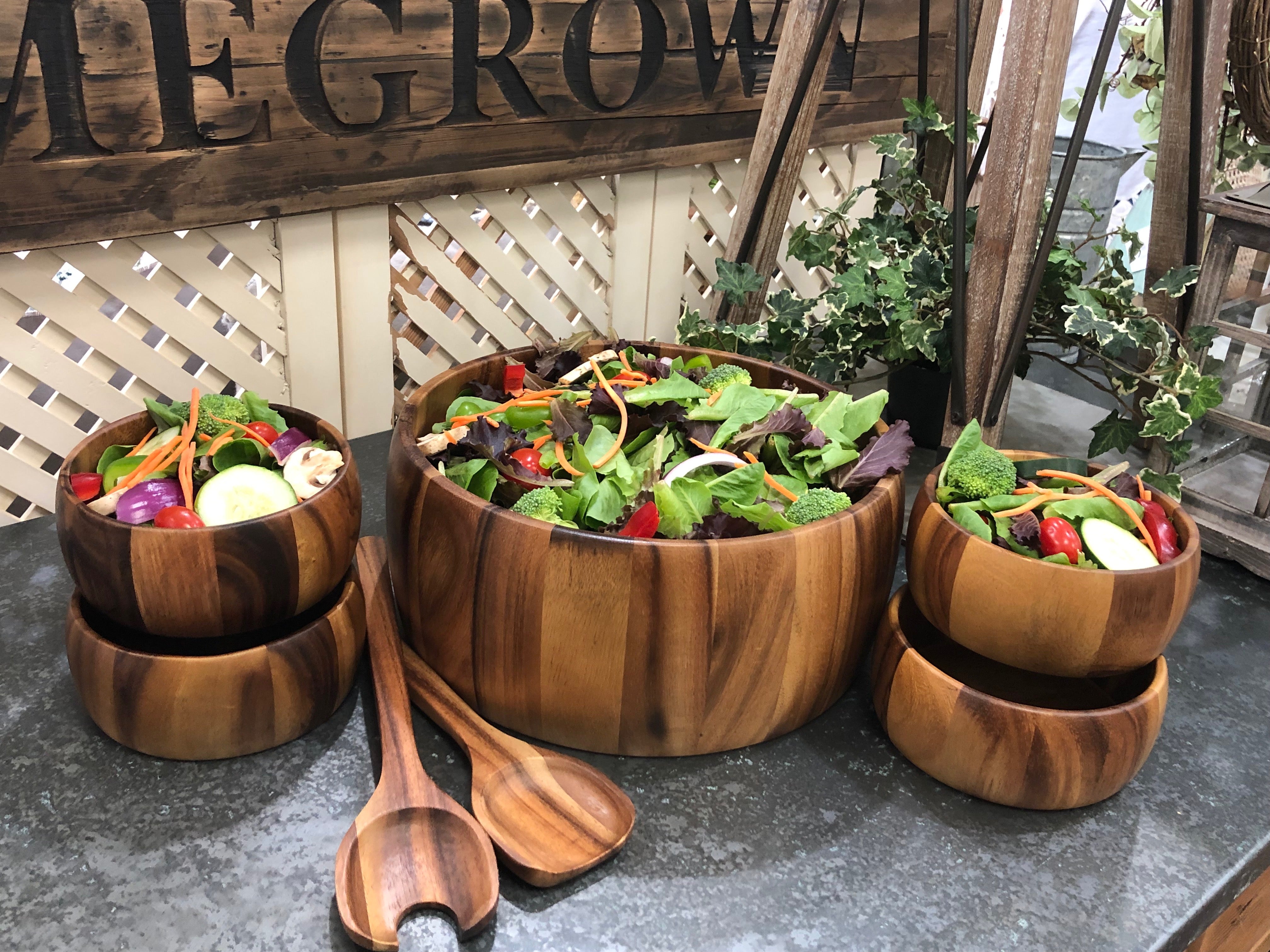 This Dragor 7-piece set features an extra large Acacia wood salad bowl, complemented by four charming individual bowls and two elegant serving utensils, beautifully arranged on a white background—making it the perfect hostess gift.