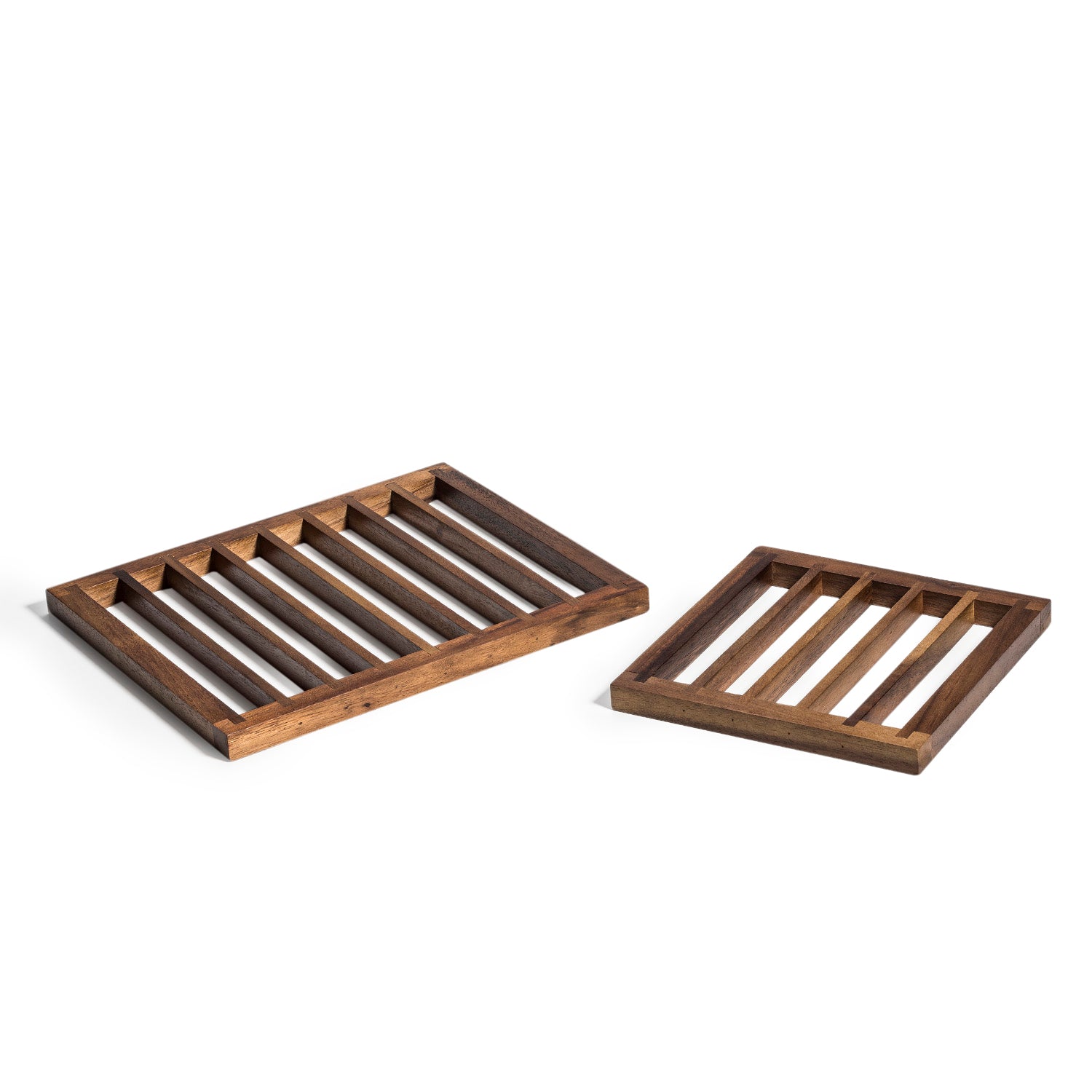 The Trivets set of 2, featuring a larger rectangular tray and a smaller square tray both crafted from acacia wood, are elegantly displayed side by side on a white background. These pieces not only enhance your decor but also offer excellent heat protection for table settings.