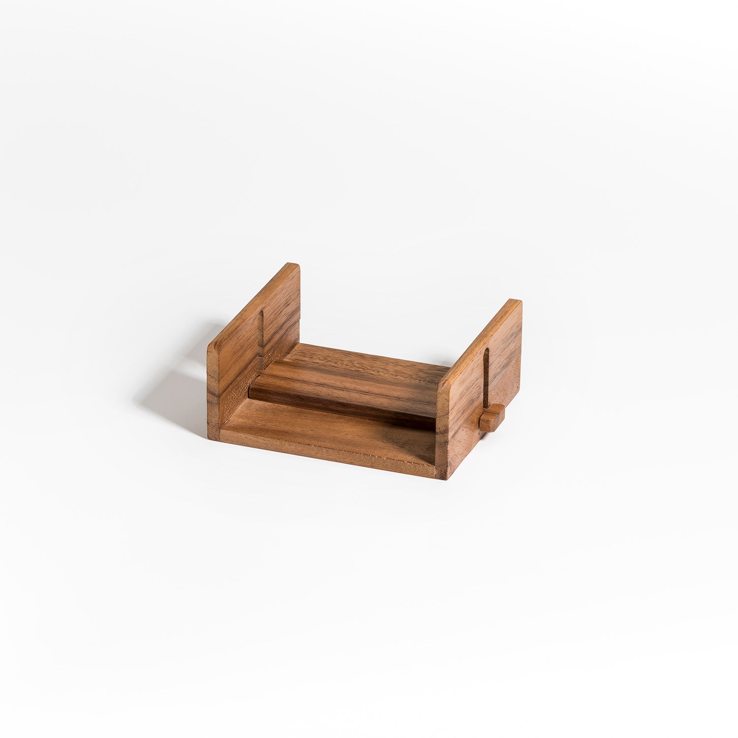 A sophisticated cocktail napkin holder, crafted from luxurious Acacia wood, is showcased against a pristine white background.