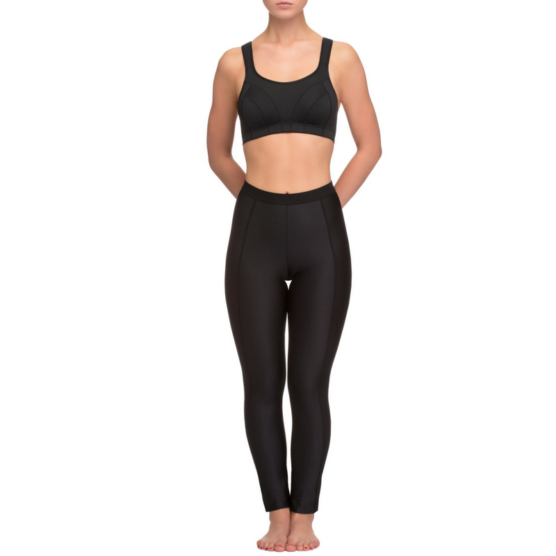 A person standing on a plain white background, wearing Long Fitness Leggings Lauma Active Lady Fitness in black, made from elastic fabric. The person is barefoot with their feet close together. Only the lower part of the body is visible, ideal for average intensity workouts.