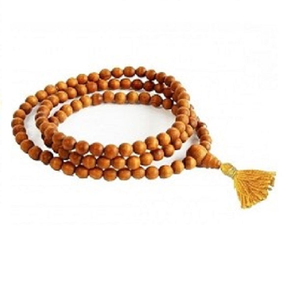 The Sandalwood Mala - 108 Beads is a handmade piece featuring sandalwood beads and a yellow tassel, elegantly arranged in a circular loop to embody the essence of spiritual jewelry.