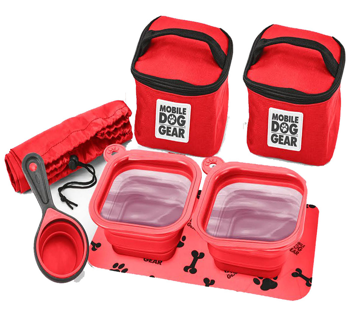 The Dine Away Bag (Med/Lg Dogs)™ features food containers, collapsible bowls, a food scoop, a placemat, and a carrying bag. A dog's photo in a speech bubble declares, "This is my gear!" It's perfectly designed for your adventurous pup's pet luggage.