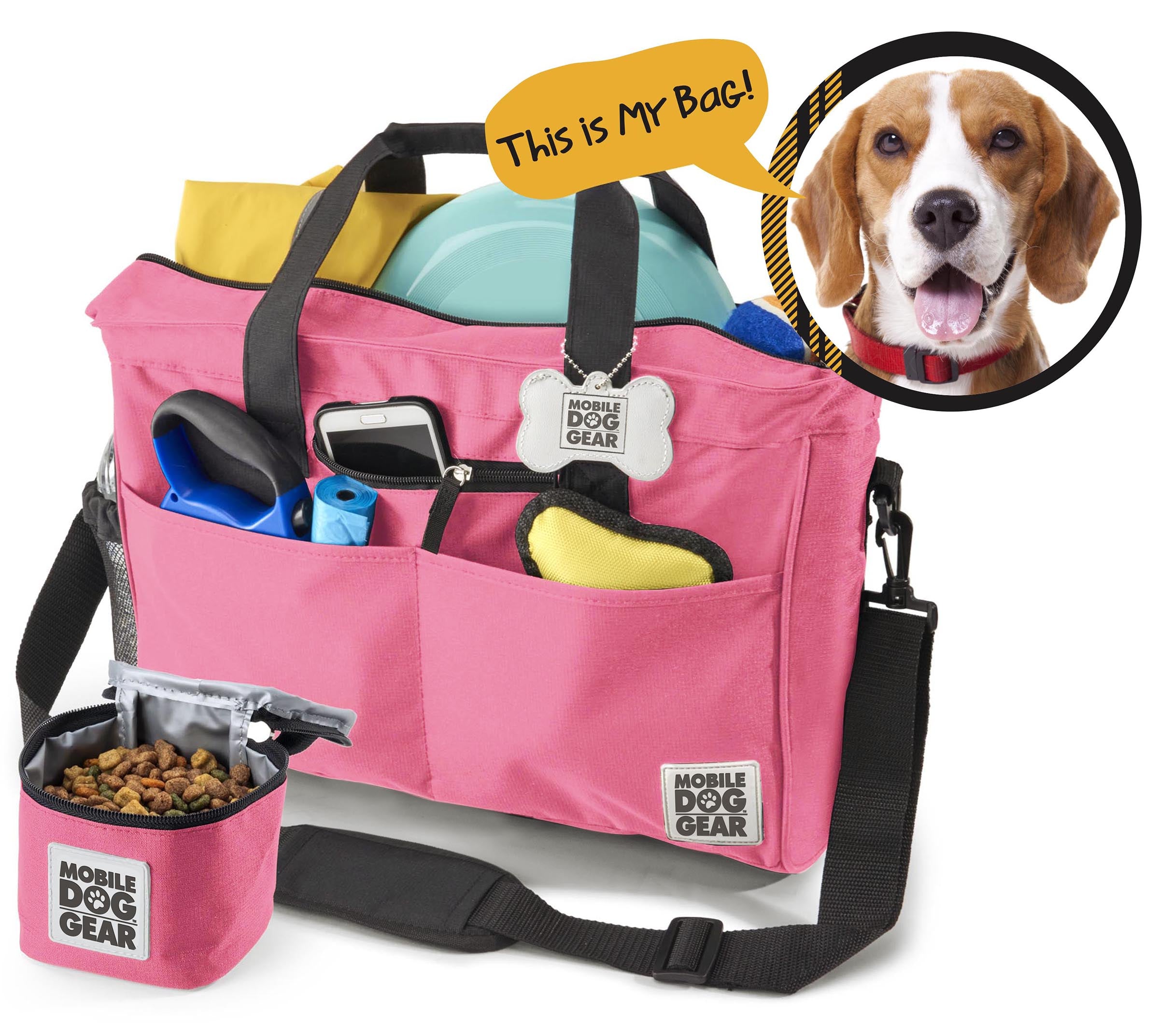 A black Day Away Tote Bag TM packed with various accessories like a phone, frisbee, and towel, accompanied by a small bag of dog food. A speech bubble from a dog image declares, "This is My Bag!" making it the perfect pet luggage for adventures.