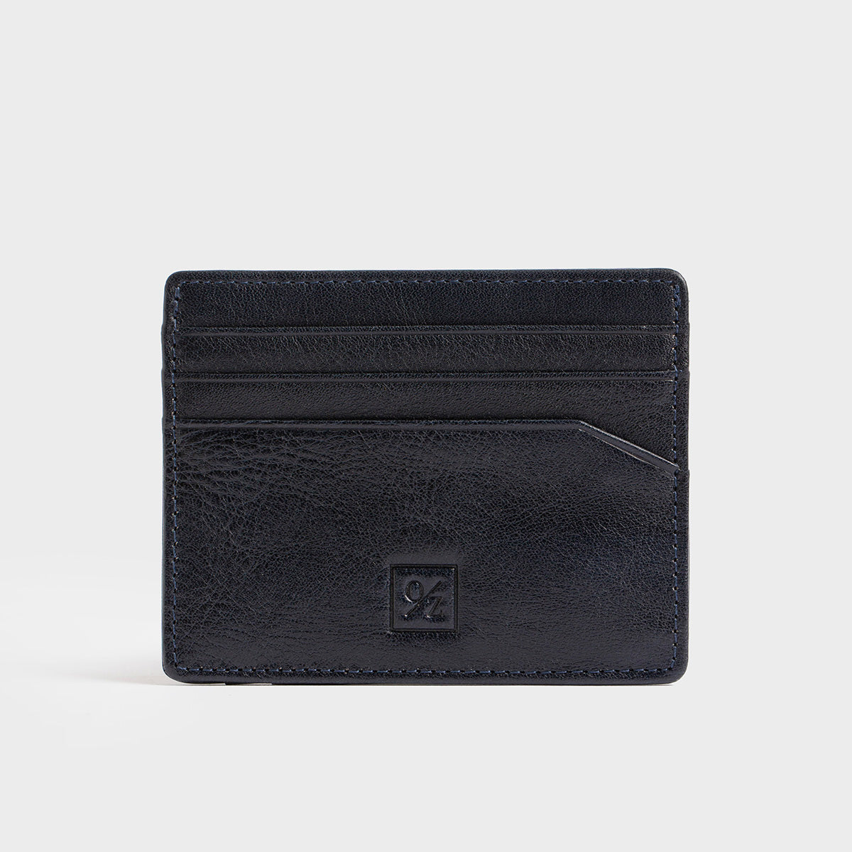 The Belforte - Slim Wallet is a stylish and lightweight black leather card-holder featuring an embossed logo, three card slots, and one easy-access side pocket. Displayed on a plain gray background, it combines elegance with functionality.