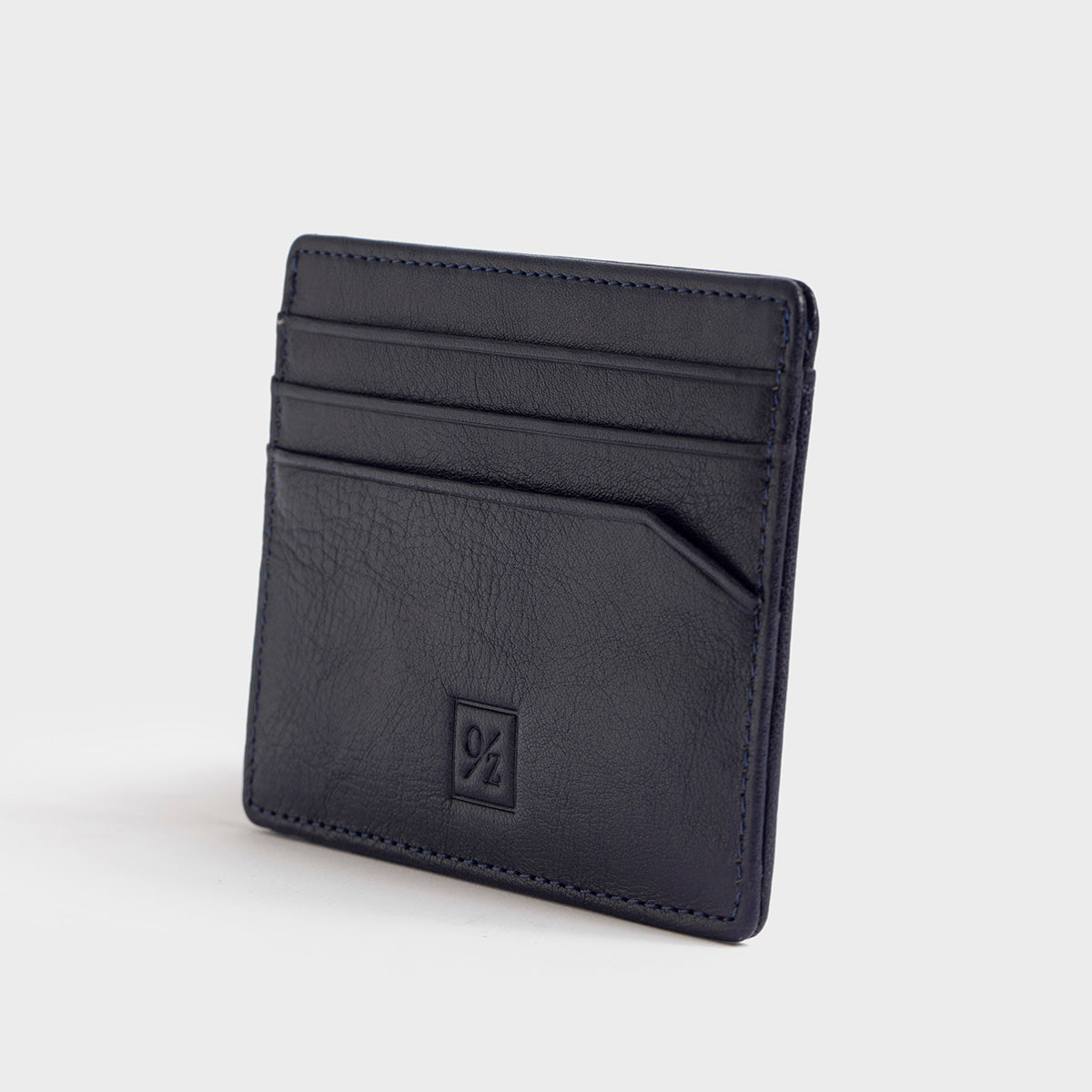 The Belforte - Slim Wallet is a stylish and lightweight black leather card-holder featuring an embossed logo, three card slots, and one easy-access side pocket. Displayed on a plain gray background, it combines elegance with functionality.