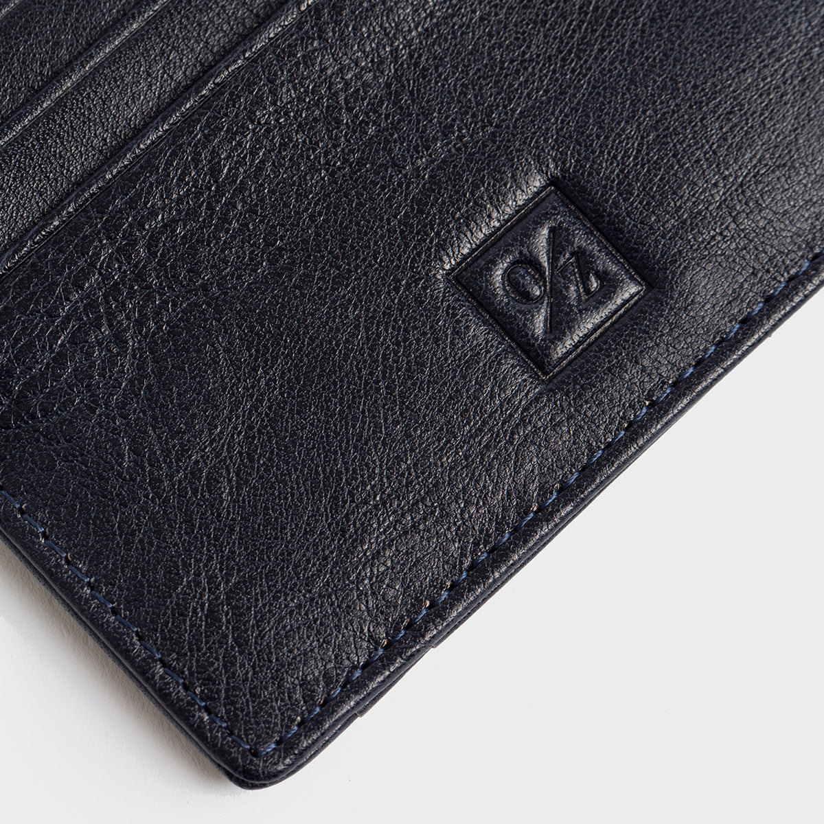 The Belforte - Slim Wallet is a stylish and lightweight black leather card-holder featuring an embossed logo, three card slots, and one easy-access side pocket. Displayed on a plain gray background, it combines elegance with functionality.