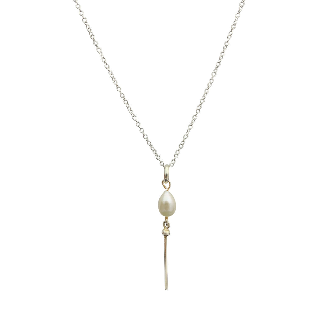 The Freshwater Pearl Bar Necklace elegantly showcases a single lustrous pearl alongside a slender sterling silver pendant on a fine chain, highlighting the artistry of handcrafted jewelry.