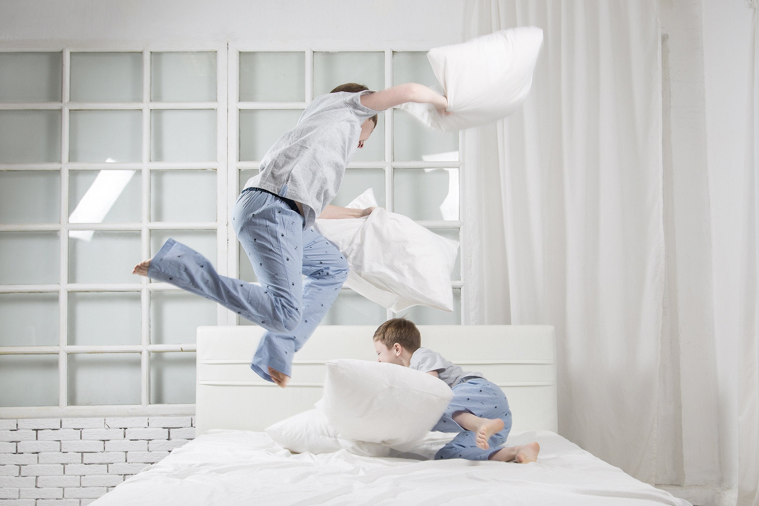 A stack of khaki sheets with wrinkles on a white background.