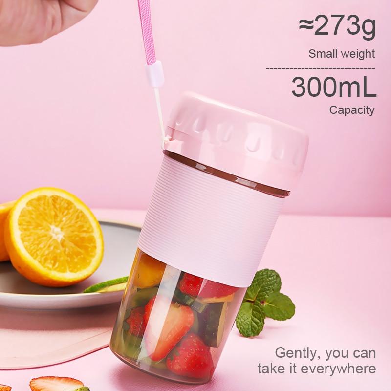 A pink and transparent Portable Personal Juice Blender and Smoothie Maker with a lid featuring a carrying strap, ribbed grip section, and translucent bottom half doubles as a personal wireless juice blender rechargeable via USB.