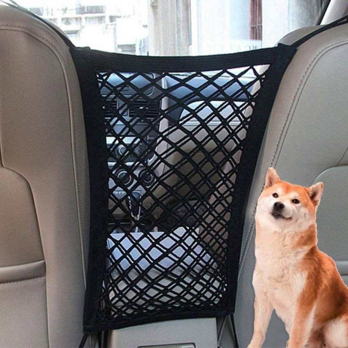 A shiba inu dog standing in a car, peeking through a black High Quality Premium Pet Car Net Petition barrier installed between two front seats.