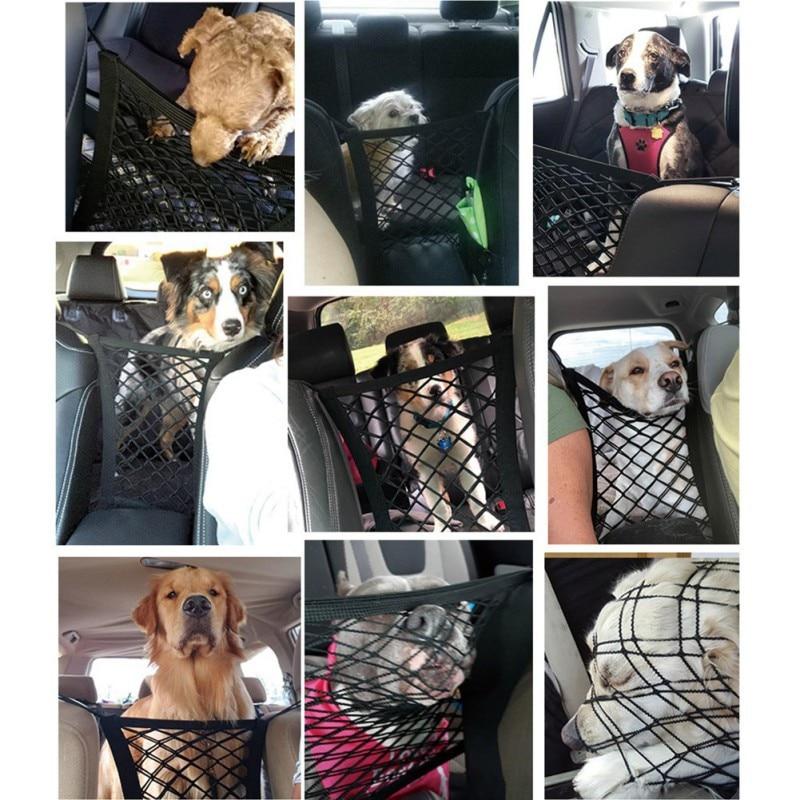 A shiba inu dog standing in a car, peeking through a black High Quality Premium Pet Car Net Petition barrier installed between two front seats.