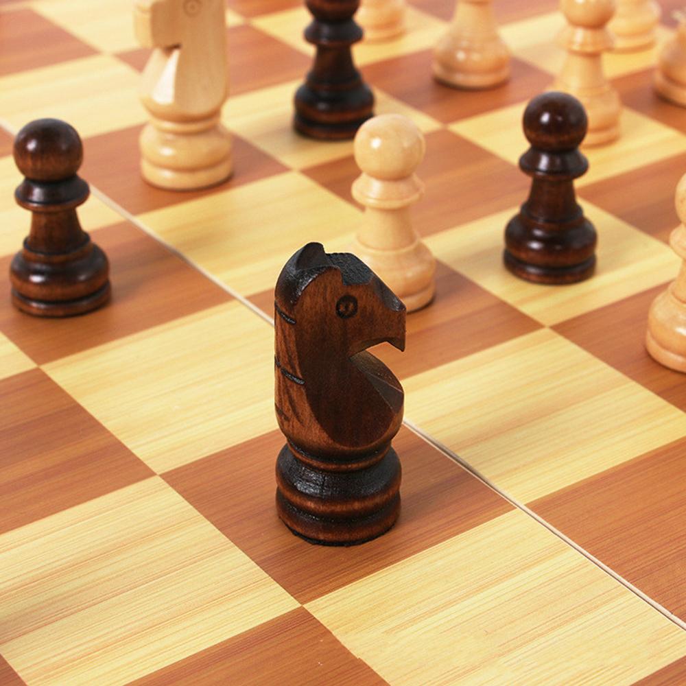 The Foldable Wooden Chess Set Board Game comes with pieces ready for a new match. Extra chess pieces and checkers are also included beneath the portable board.