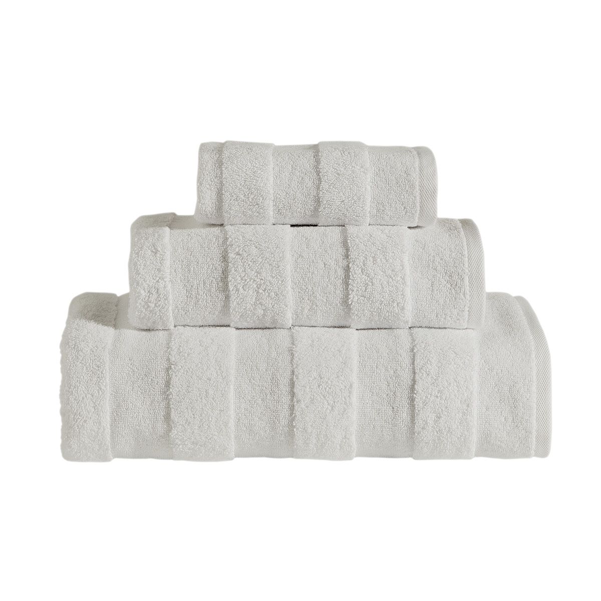 The Apogee Collection 3 PK Towels Set, featuring luxurious towels in white, blue, pink, and gray, is expertly arranged on a shelf. Nearby, small bottles and bars of soap complement the display with their decorative touch. Crafted from ultra-soft cotton, these towels enhance any bathroom experience with their plush texture.