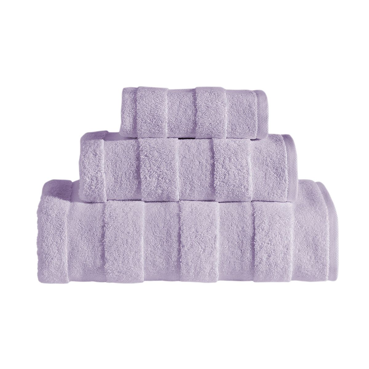 The Apogee Collection 3 PK Towels Set, featuring luxurious towels in white, blue, pink, and gray, is expertly arranged on a shelf. Nearby, small bottles and bars of soap complement the display with their decorative touch. Crafted from ultra-soft cotton, these towels enhance any bathroom experience with their plush texture.