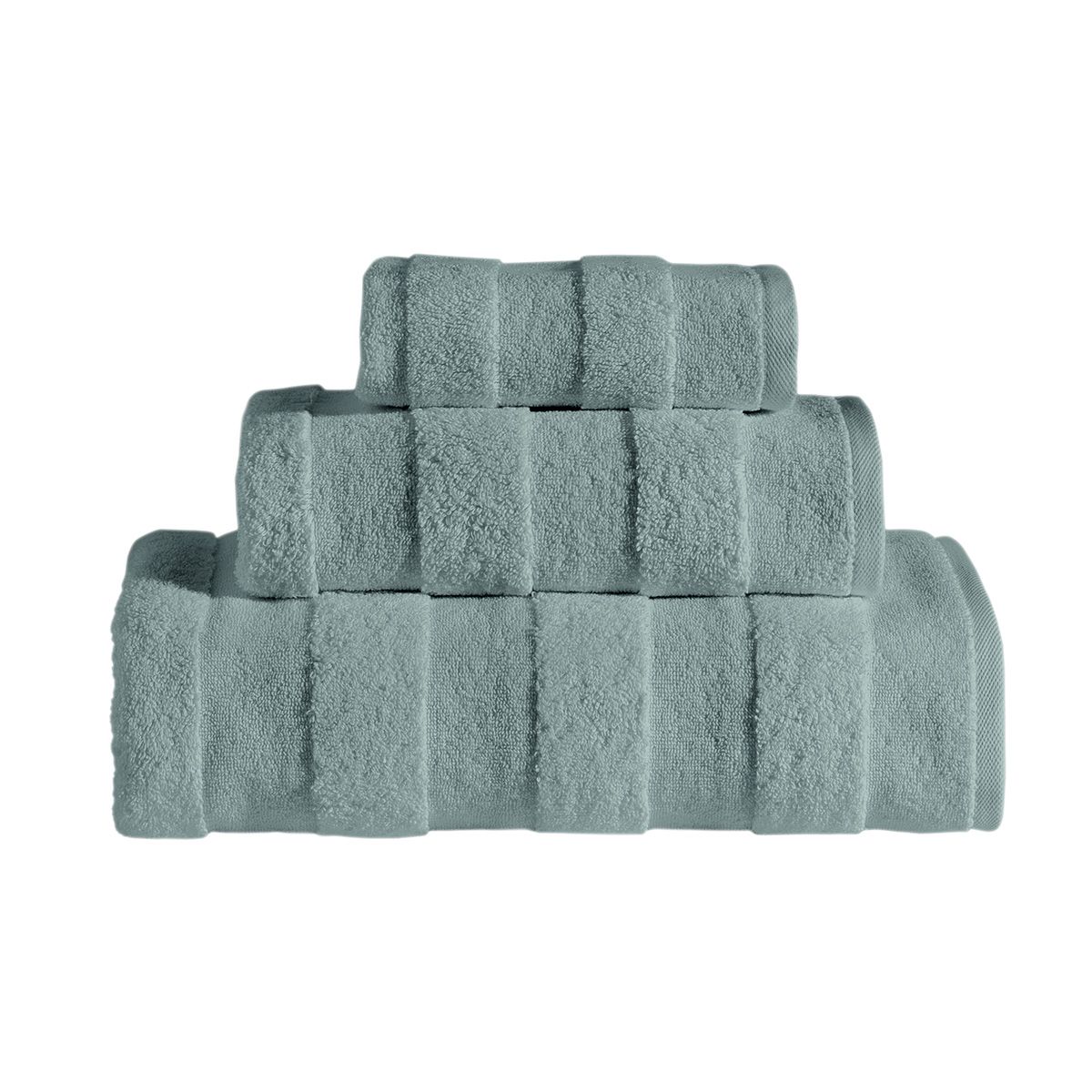 The Apogee Collection 3 PK Towels Set, featuring luxurious towels in white, blue, pink, and gray, is expertly arranged on a shelf. Nearby, small bottles and bars of soap complement the display with their decorative touch. Crafted from ultra-soft cotton, these towels enhance any bathroom experience with their plush texture.