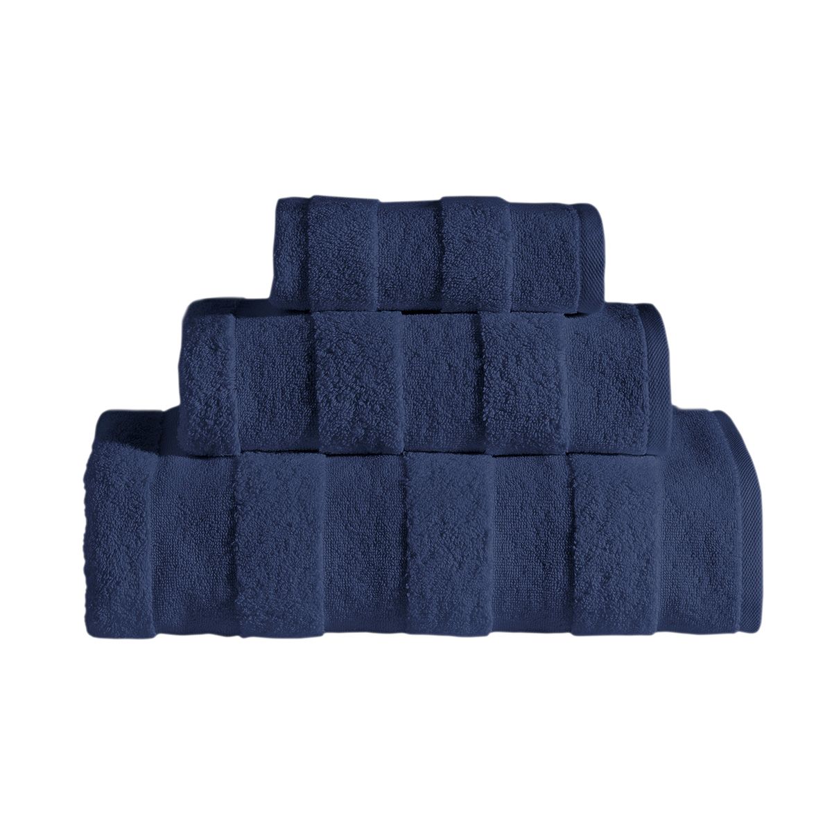 The Apogee Collection 3 PK Towels Set, featuring luxurious towels in white, blue, pink, and gray, is expertly arranged on a shelf. Nearby, small bottles and bars of soap complement the display with their decorative touch. Crafted from ultra-soft cotton, these towels enhance any bathroom experience with their plush texture.