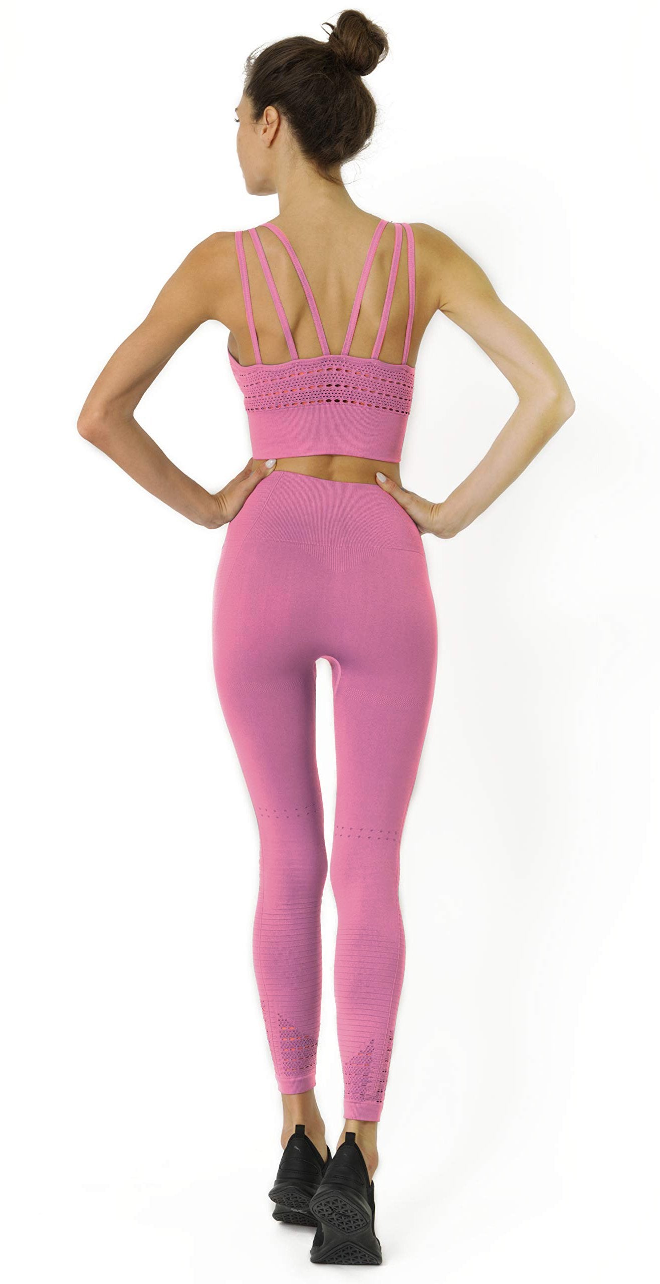 A person is wearing Mesh Seamless Leggings with ribbing detail in pink, featuring a high waistband, standing against a white background.