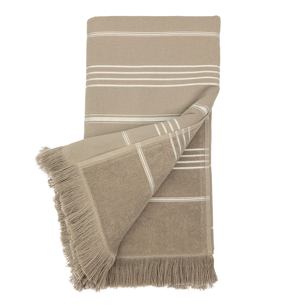 The Classic Terry Turkish Towel is a handmade white towel featuring horizontal gray stripes and fringed edges, ideal for enhancing the elegance of your bath collection.