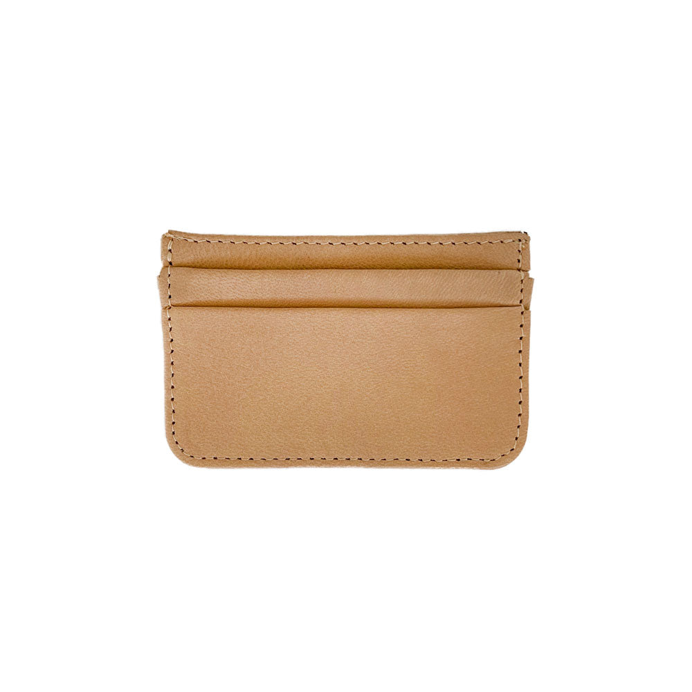 The Coco Card Holder is a minimalist tan and cream cowhide leather accessory, complete with stitched edges and practical card slots.