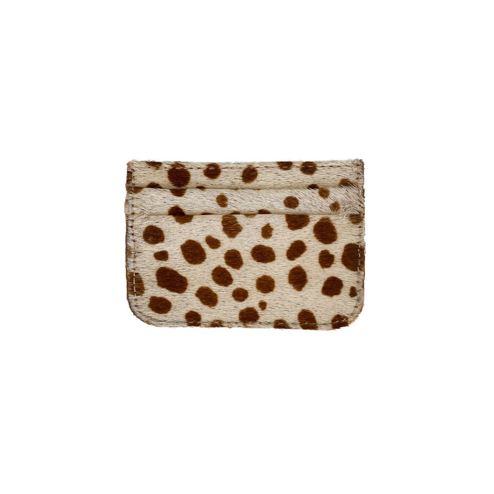 The Coco Card Holder is a minimalist tan and cream cowhide leather accessory, complete with stitched edges and practical card slots.