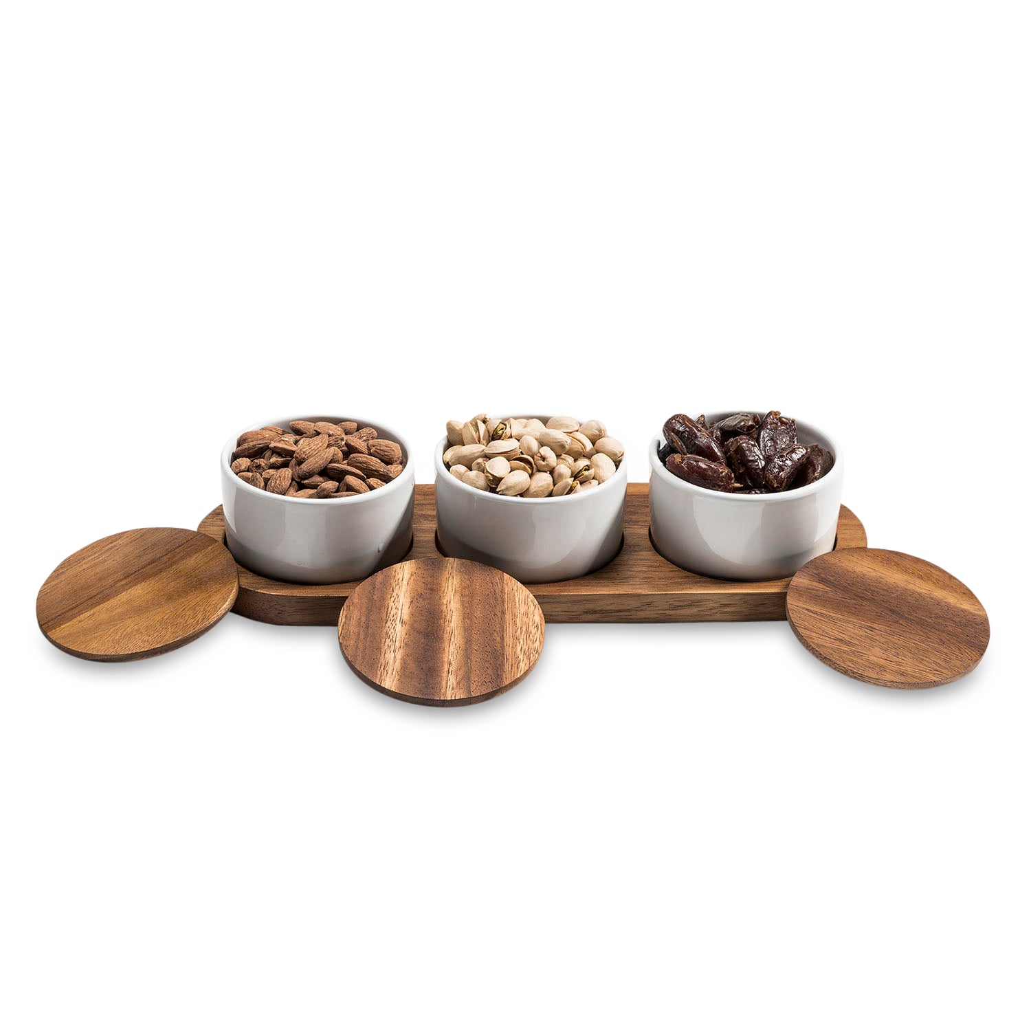 The Condiment Serving Set, featuring three ceramic bowls with wooden lids, is elegantly displayed on an acacia wood tray measuring 13" x 3.75".