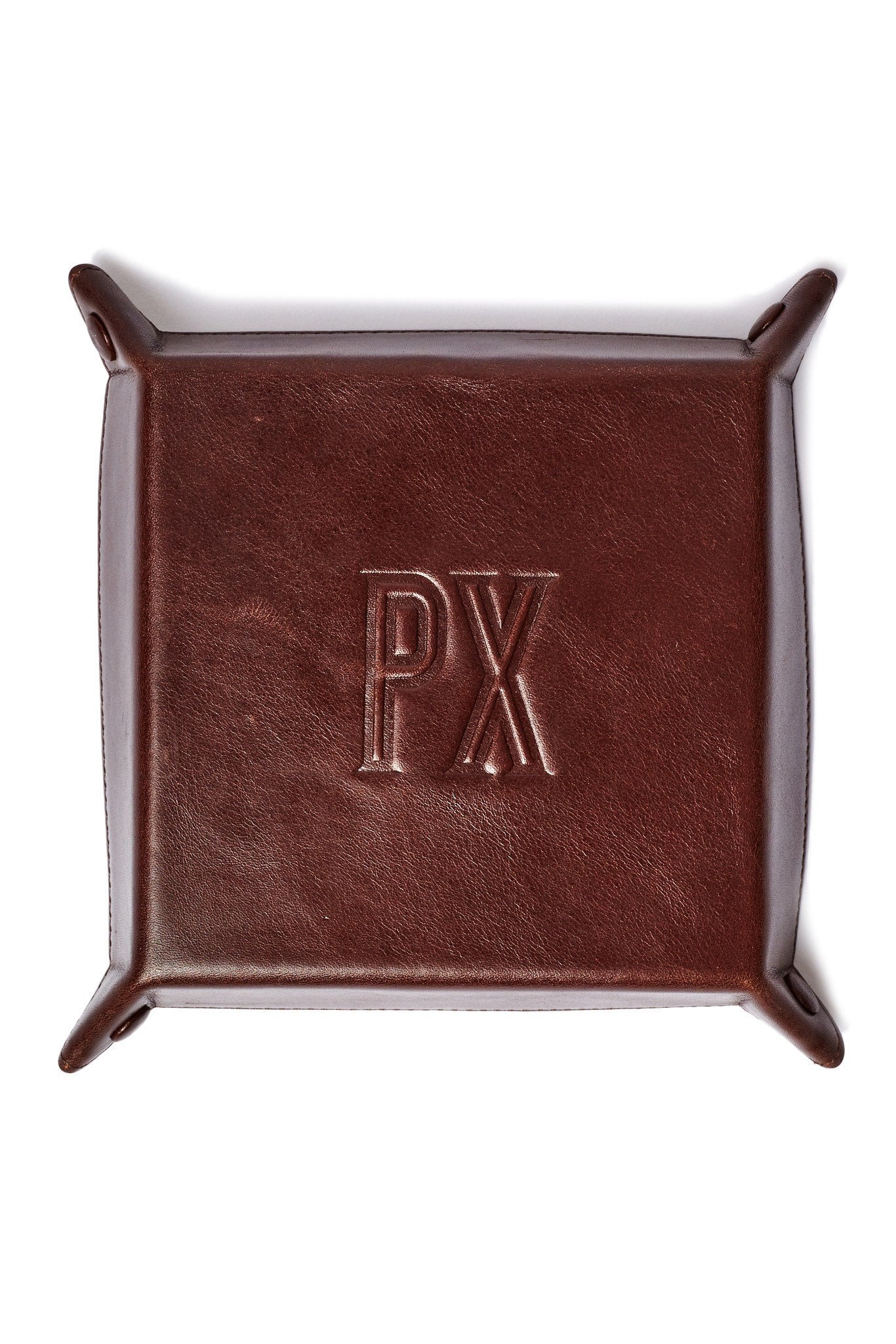 The Floyd Foldable Valet Tray is a rectangular leather organizer featuring raised sides and corner buttons, ideal for storing small items such as keys.