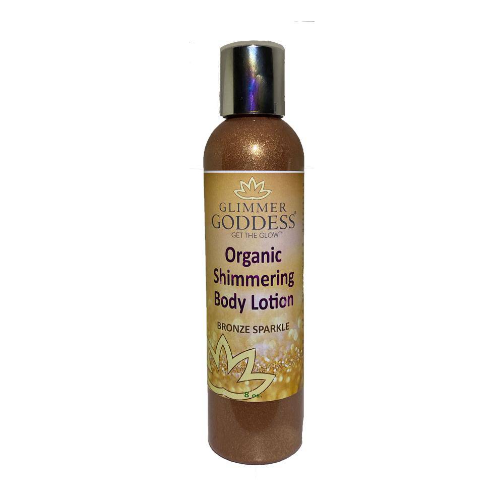 A bottle of Glimmer Goddess Organic Shimmer Body Lotion - Sparkle For All Skin Types with a gold sparkle label, isolated on a white background.