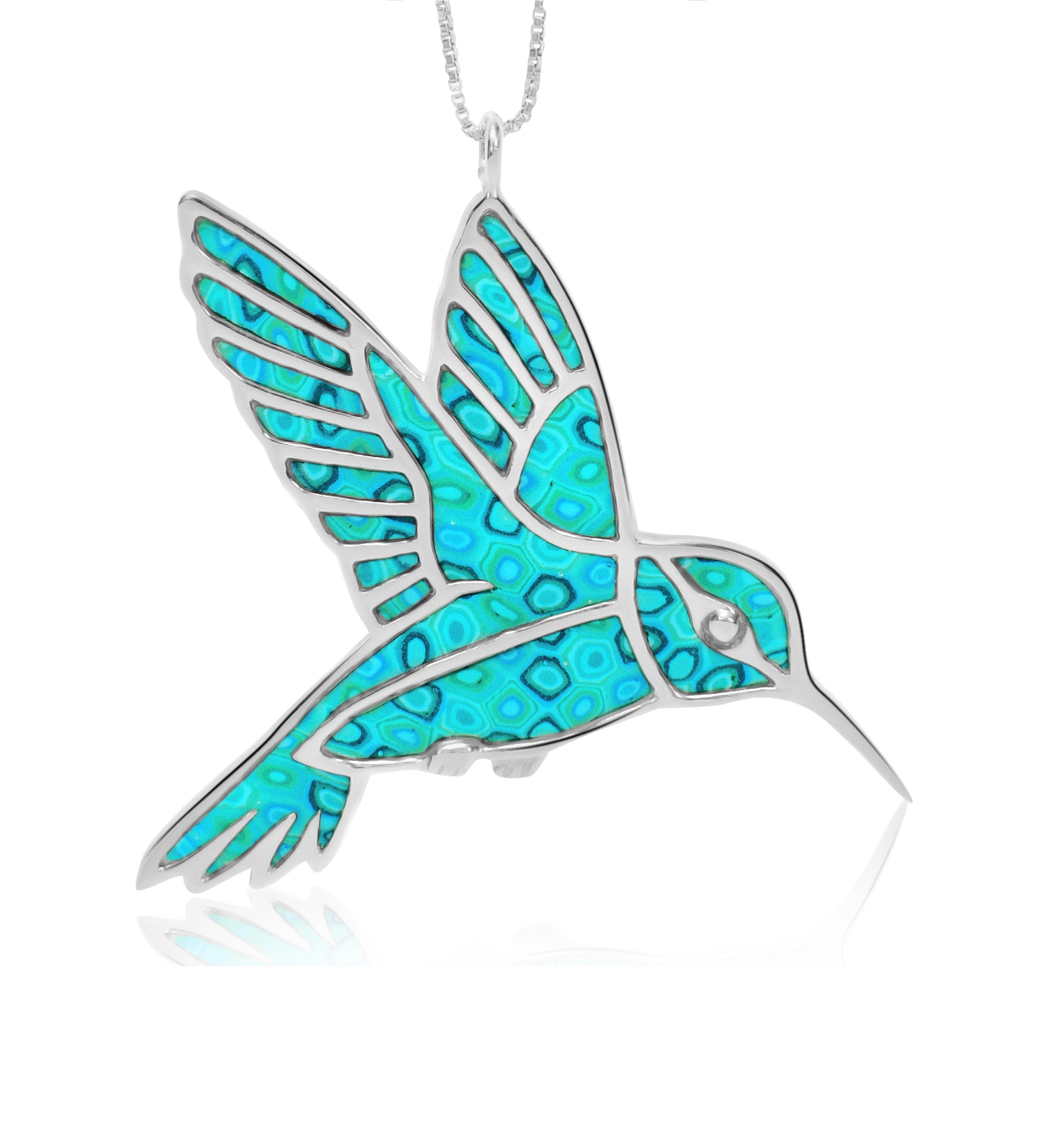 A woman with windswept hair, wearing a sequined top and a 925 Sterling Silver Hummingbird Necklace Handcrafted Pendant, smiling against a white background.
