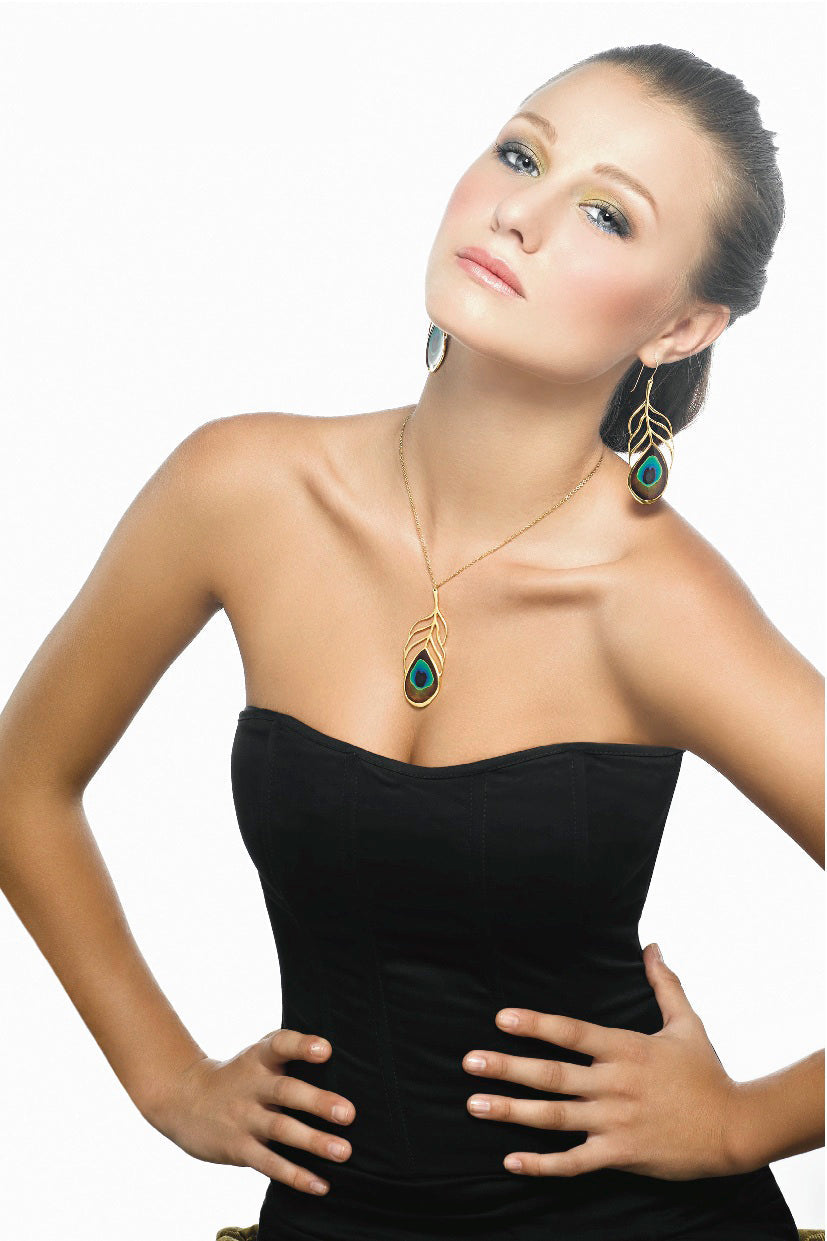 Woman with an elegant updo hairstyle, wearing a black strapless dress and smiling, with a Gold Plated 925 Sterling Silver Peacock Feather Necklace Handcrafted Pendant and green earrings. White background.