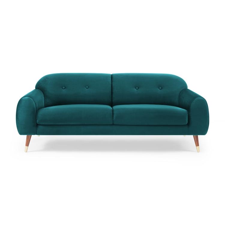 A Velvet Two-seat Sofa with Wide Flared Armrests in front of a white wall.