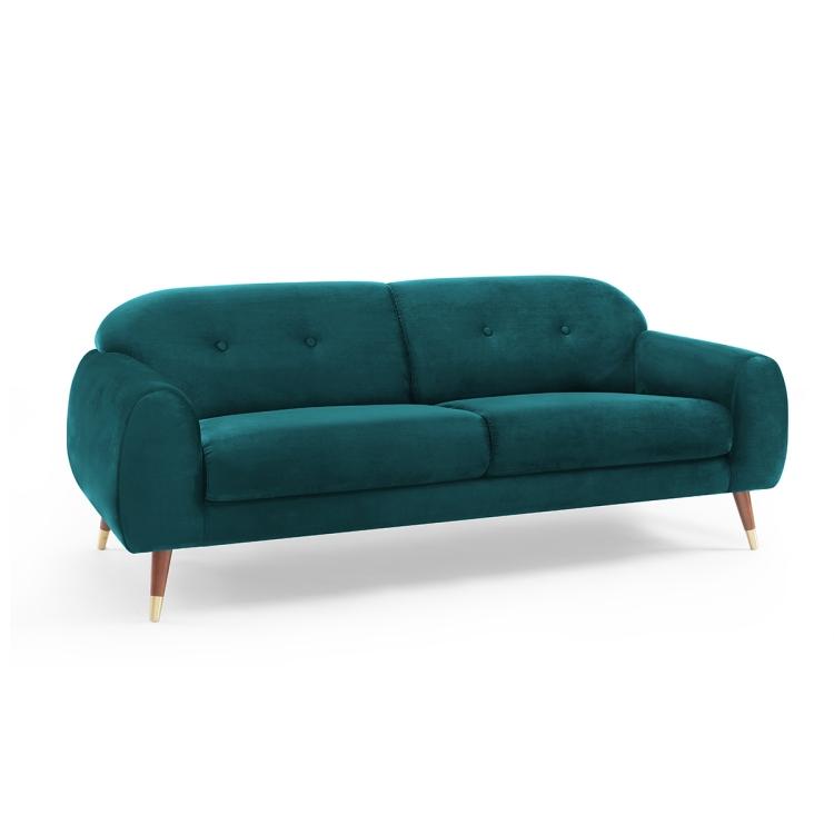 A Velvet Two-seat Sofa with Wide Flared Armrests in front of a white wall.