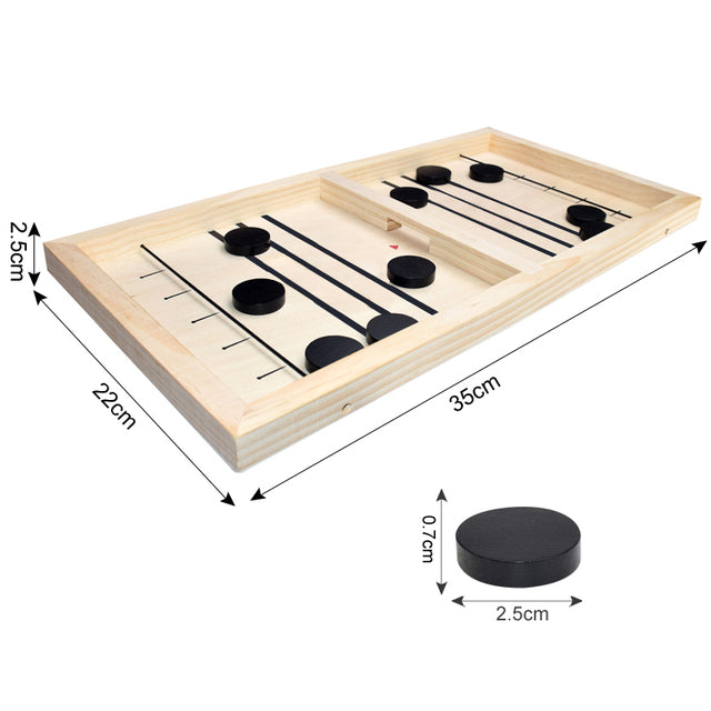 A person is playing a game of Sling Puck Table Hockey Game on a wooden board.