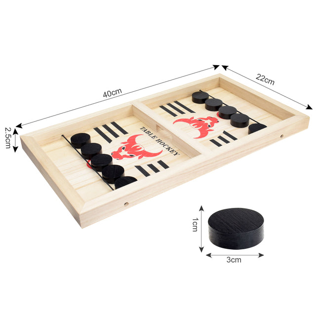 A person is playing a game of Sling Puck Table Hockey Game on a wooden board.