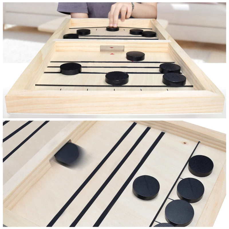 A person is playing a game of Sling Puck Table Hockey Game on a wooden board.